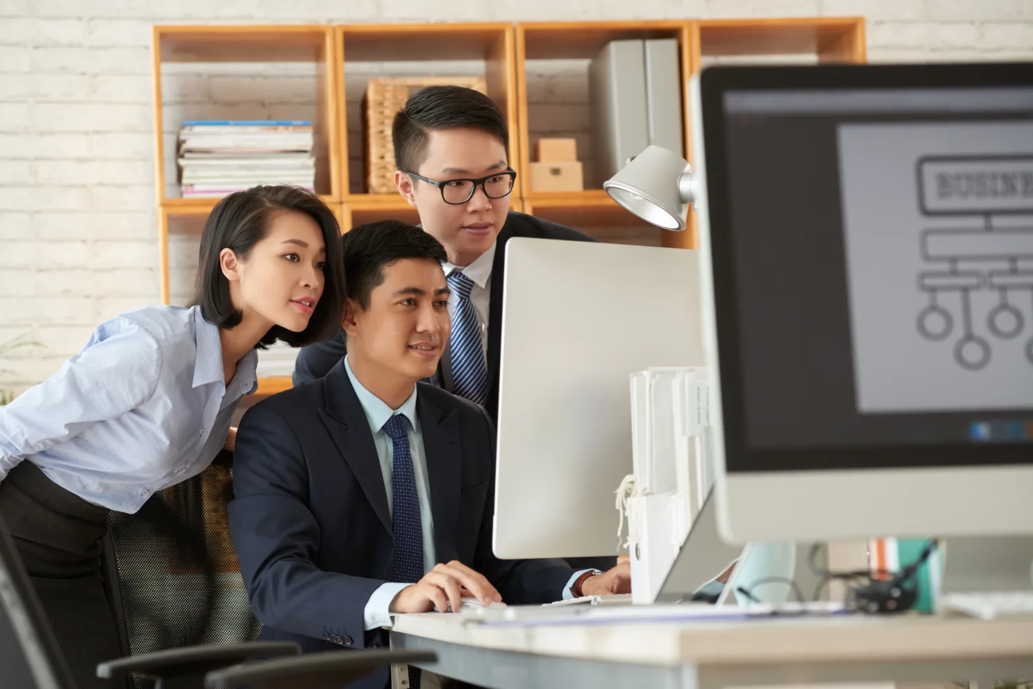 Technology team collaborating at a screen